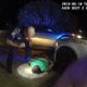 This image from video from Louisiana state police state trooper Dakota DeMoss’ body-worn camera, shows trooper Kory York bending over with his foot on Ronald Greene’s shoulder after he was taken into custody on May 10, 2019, outside of Monroe, La.